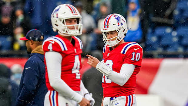 New England Patriots quarterback Mac Jones (10) and quarterback Bailey Zappe (4) in the field to warm up before the start of the game against the Los Angeles Chargers at Gillette Stadium.
